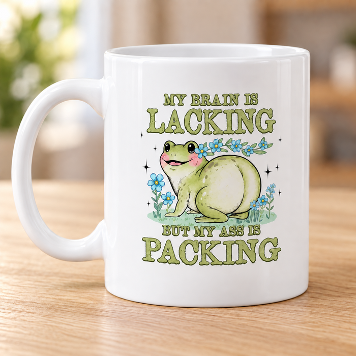 White frog mug reading My brain is lacking but my ass is packing
